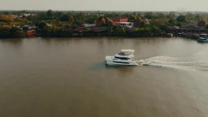 Aquila 44 drifting on a wide reach of the river