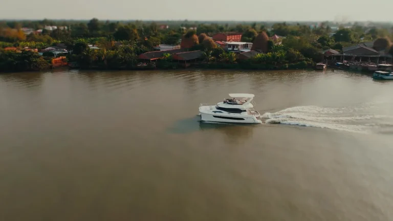 Aquila 44 drifting on a wide reach of the river