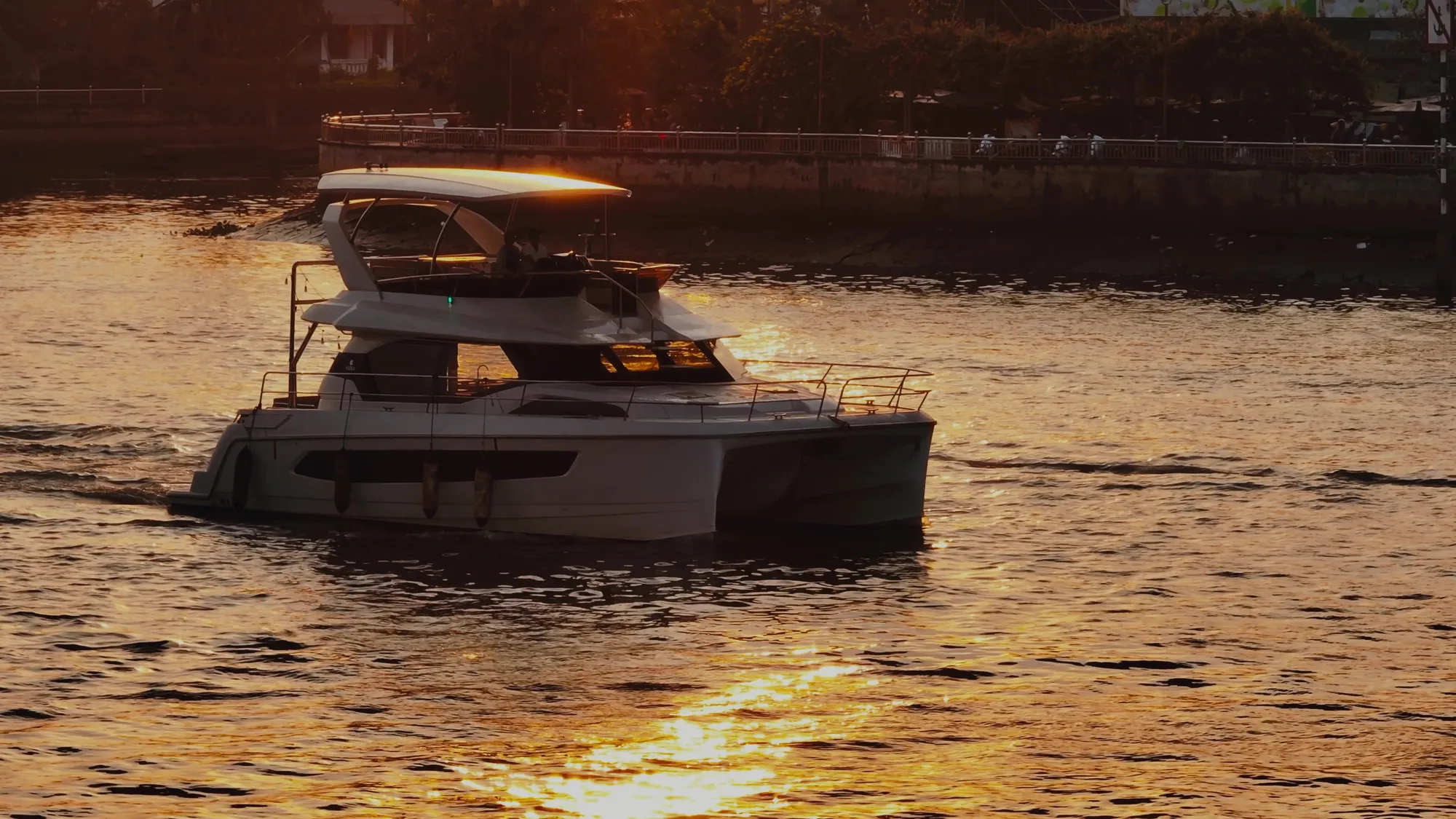 Aquila 44 under way on the river at sunset